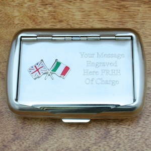 May include: A silver cigarette case with a hinged lid. The case features a crossed British and Italian flag design and the text "Your Message Engraved Here FREE Of Charge".