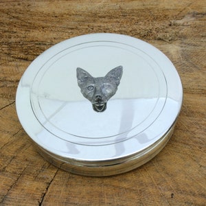 May include: A silver round trinket box with a raised pewter fox head on the lid.
