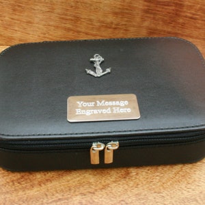 May include: Black leather travel case with a silver anchor charm and a silver plaque that says "Your Message Engraved Here".