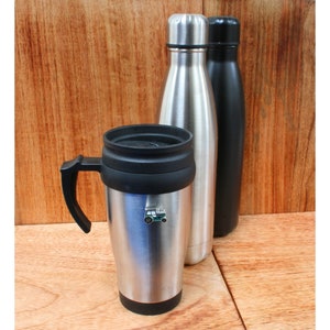 May include: A silver travel mug with a black lid and handle, a silver water bottle, and a black water bottle. The travel mug has a small green car decal on the side.