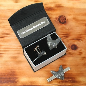 May include: A black gift box with a silver plate that says "Your Message Engraved Here". The box contains a pair of cufflinks and a tie clip featuring a fox head design.