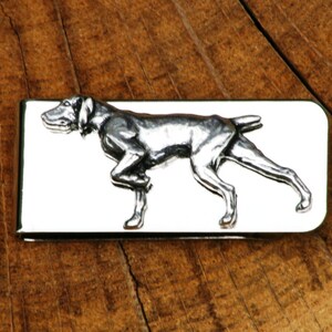 May include: Silver money clip featuring a detailed, three-dimensional design of a German Shorthaired Pointer dog in a running pose.