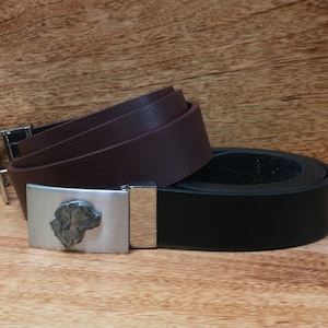 May include: Two leather belts with a silver buckle featuring a dog's head. The top belt is brown and the bottom belt is black.