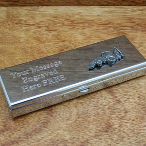 May include: A silver metal box with a tractor design on the lid. The box has an inscription that reads "Your Message Engraved Here FREE".