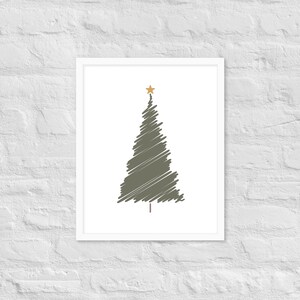 May include: A framed wall art print featuring a stylized, olive green Christmas tree created with a scribbled, hand-drawn line effect. The tree is topped with a small, solid gold star and has a simple brown trunk, all set against a plain white background.