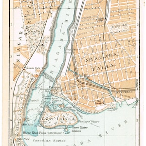 May include: A vintage-style printed map of Niagara Falls featuring the Niagara River, Goat Island, and surrounding city streets. The map uses a color palette of tan, light blue, and black ink, including a scale bar in feet and meters at the bottom.