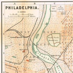 May include: A vintage map of Philadelphia featuring Fairmount Park, the Schuylkill River, and the East Park Reservoir. The map includes a grid system, a scale bar in feet and meters, and labels for landmarks like Belmont Mansion and Memorial Hall.