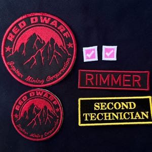 May include: A set of three ceramic mugs with a speckled, matte finish. The mugs are in shades of cream, light gray, and dark gray. Each mug has a simple, minimalist design and a rounded handle.