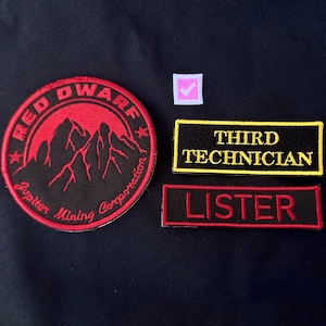May include: A set of embroidered patches including a circular red and black patch with a mountain graphic and the text RED DWARF JUPITER MINING CORPORATION, a rectangular black patch with yellow text THIRD TECHNICIAN, and a red and black name patch LISTER.