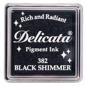May include: Black ink pad with silver trim, labeled "Delicata Pigment Ink 382 BLACK SHIMMER" and "Rich and Radiant".
