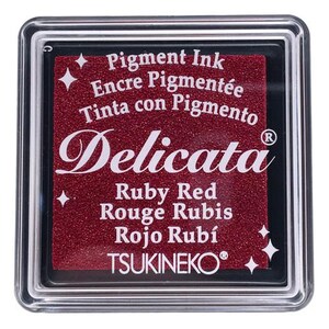 May include: A red ink pad with the text "Pigment Ink", "Encre Pigment&eacute;e", "Tinta con Pigmento", "Delicata", "Ruby Red", "Rouge Rubis", "Rojo Rub&iacute;", and "TSUKINEKO&reg;".