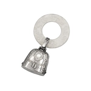 May include: Silver baby rattle with a white teething ring. The rattle features a clock face with the inscription "Birth Record" and "Year 1954".