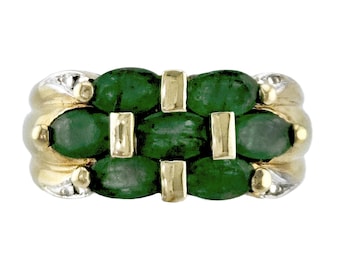 May include: A gold and silver ring featuring a woven design of oval-cut, deep green gemstones. The ring has a two-tone metal band with a textured, ribbed design on the sides, and gold accents.