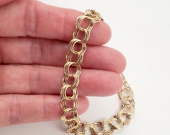 Sold at Auction: JEWELRY: Charm bracelet, stamped 14K, yellow gold oval  link bracelet with spring ring clasp and safety chain, containing eleven  14K and three gold filled charms, including 14K yellow gold 