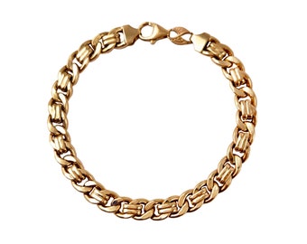 May include: A gold chain bracelet with a box chain design. The bracelet has a lobster clasp closure.