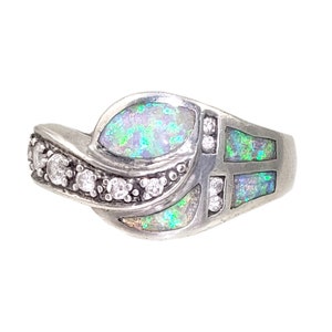 May include: A silver ring with a green and white opal stone and clear cubic zirconia stones.
