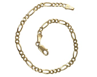 May include: A gold chain bracelet with a figaro link pattern.