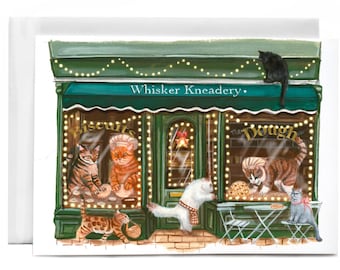Peut inclure: Carte de vœux avec une illustration d'une boulangerie pour chats appelée "Whisker Kneadery". La boutique a une façade verte avec des guirlandes lumineuses et des chats à l'intérieur. Les chats sont vus en train de cuisiner et de déguster des friandises. Un chat noir est assis sur le toit.