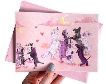 Dancing in the moonlight Pagan card | Dog and Cat dancing holding paws | Cottagecore, witchy, celestial, love greetings card