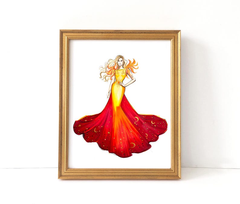 May include: A framed watercolor print of a woman in a flowing gown. The dress transitions from yellow to red, adorned with stars and crescent moons. The artwork is set in a gold frame, creating a striking visual.
