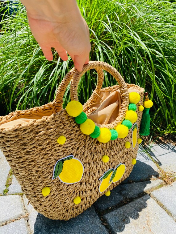Straw handbag with pom poms best sale