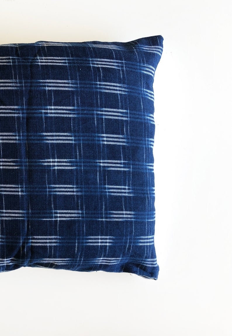 May include: A blue and white checkered pillow with a soft, textured fabric.