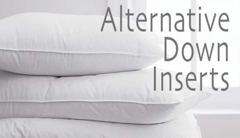 May include: Three white down alternative pillow inserts stacked on top of each other. The text "Alternative Down Inserts" is visible in the background.