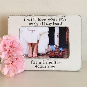 May include: White wooden picture frame with a black inscription that reads "I will love your son with all my heart for all my life, courtney". The frame has a photo of a couple in the center.