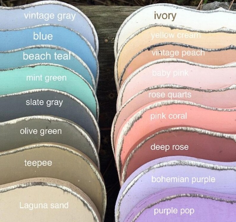 May include: A collection of 17 paint color swatches, each with a different color and name. The colors range from light to dark and include shades of blue, green, gray, pink, purple, and beige. The names of the colors are written in white text on each swatch.