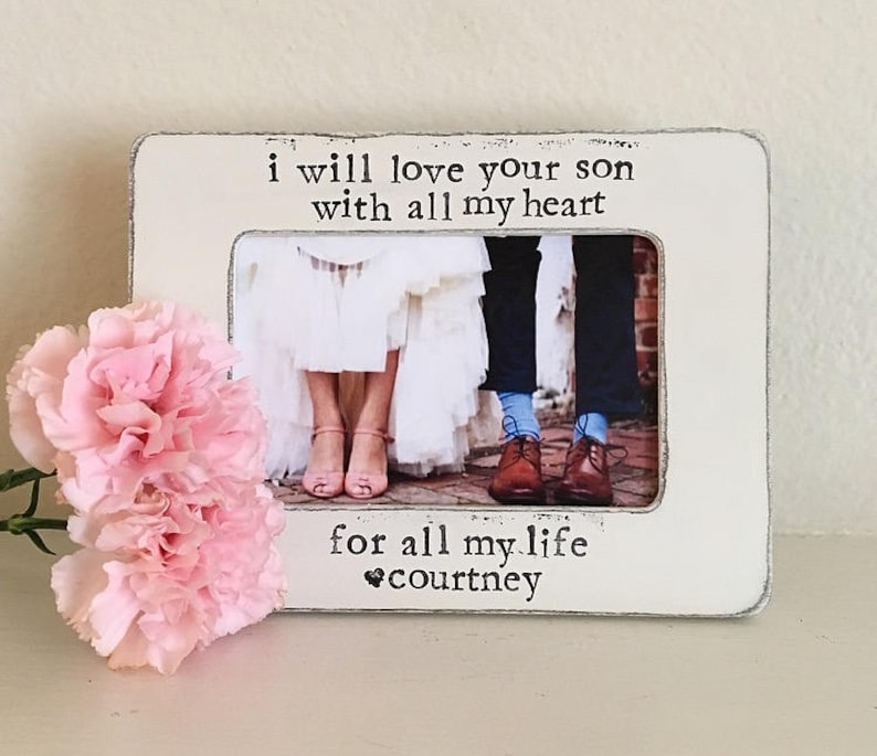 May include: White wooden picture frame with a black inscription that reads "I will love your son with all my heart for all my life, courtney". The frame has a photo of a couple in the center.