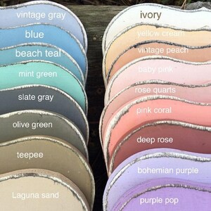 May include: A collection of paint color swatches in various shades of blue, green, gray, brown, pink, and purple. The swatches are arranged in two rows, with the names of each color written below them. The colors are: vintage gray, blue, beach teal, mint green, slate gray, olive green, teepee, Laguna sand, ivory, yellow cream, vintage peach, baby pink, rose quarts, pink coral, deep rose, bohemian purple, and purple pop.