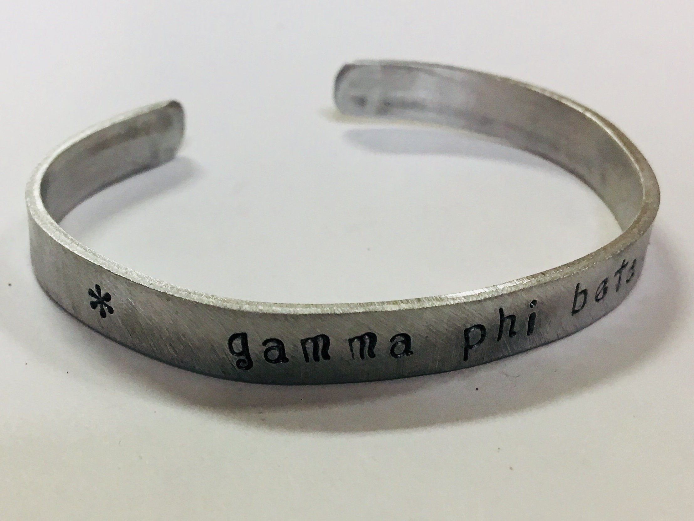 Alpha Phi Cuff Bracelet officially licensed handstamped in a whimsical font on a non tarnish aluminum cuff