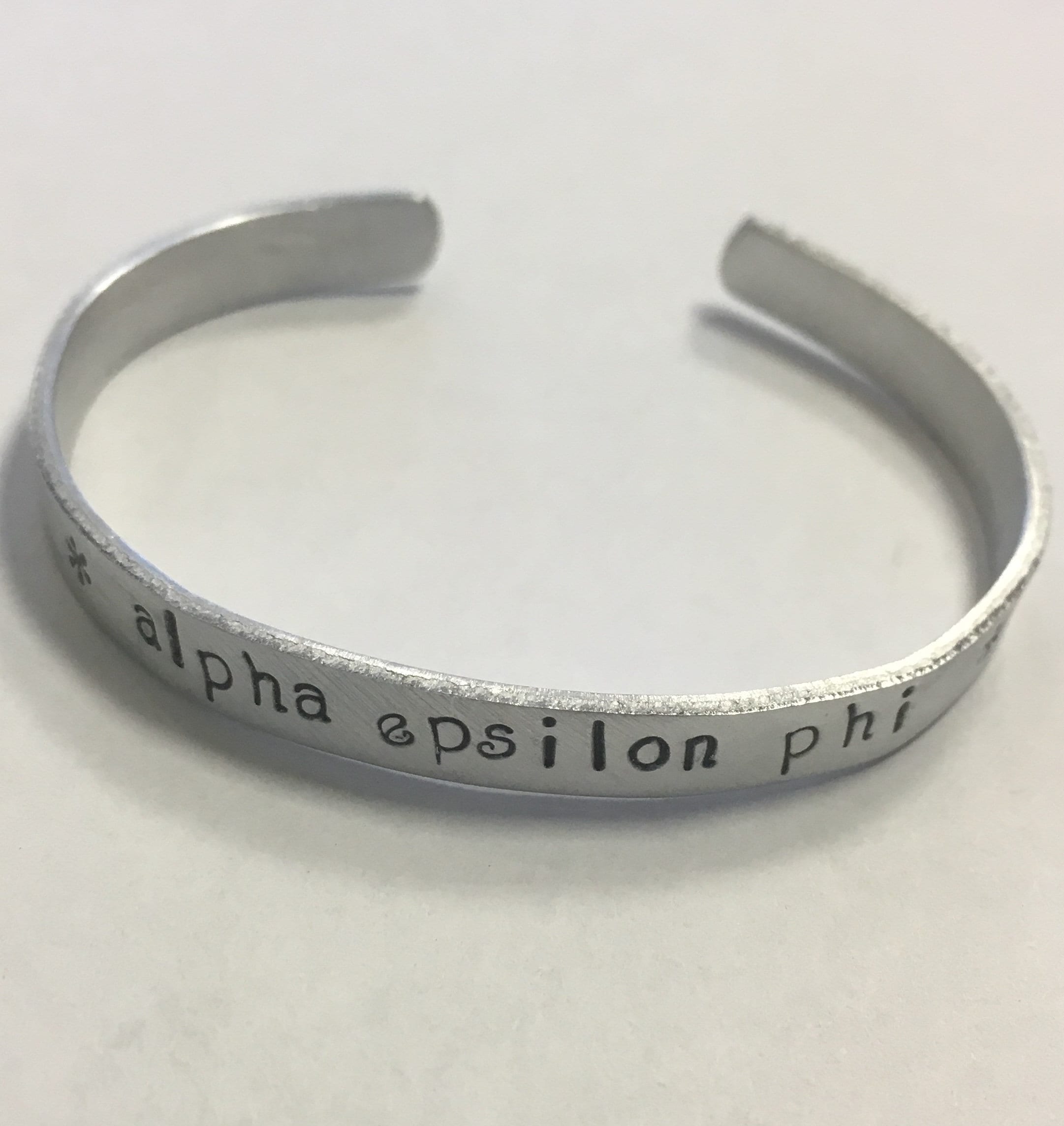 Alpha Phi Cuff Bracelet officially licensed handstamped in a whimsical font on a non tarnish aluminum cuff