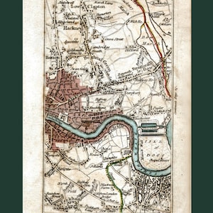May include: An antique map of London, England, from 1800. The map shows the River Thames, the Isle of Dogs, and various neighborhoods including Hackney, Bethnal Green, and Stepney. The map is printed in black, brown, and blue ink on a cream-colored paper.