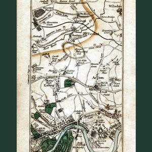 May include: An antique map of the area around London, England, showing the towns of Acton, Ealing, and Twyford. The map is printed in black and white with green areas indicating parks and fields. The map includes the names of streets, roads, and landmarks.