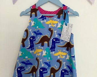 Pinafore dress, with dinosaur print and matching buttons sizes 0-3 years