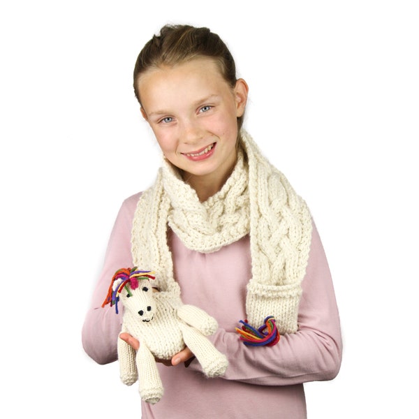 Ulysses Unicorn Scarf Knitting Pattern (UK). Pattern for child's scarf with pockets & rainbow unicorn toy puppet. Simple cable pattern.