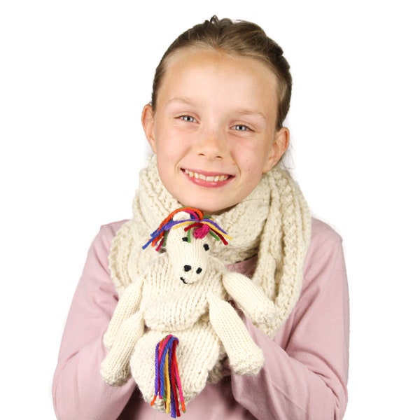 Ulysses Unicorn Scarf Knitting Pattern (US). Child's scarf with a simple cable pattern, hand warming pockets and unicorn toy. Pdf download.