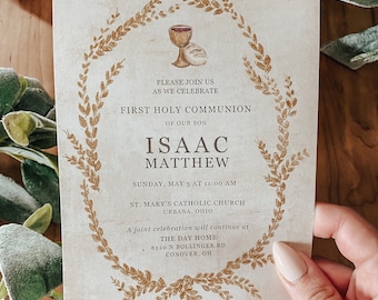 May include: A beige card with a gold floral border and a chalice and host illustration. The text reads "Please join us as we celebrate First Holy Communion of our son Isaac Matthew. Sunday, May 5 at 11:00 AM. St. Mary's Catholic Church, Urbana, Ohio. A joint celebration will continue at The Day Home, 6520 N Bollinger Rd, Conover, OH."