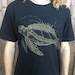 Sibyl Harrington reviewed Marine Metropolis - Unisex Organic Cotton Tee Shirt - / Sea Turtle / Nature / ocean / underwater / space / spaceship / creature / futuristic