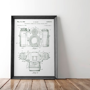 May include: A vintage green and white patent drawing of a photographic camera with coupled exposure meter. The patent number is 3,034,411 and the date is May 15, 1962.