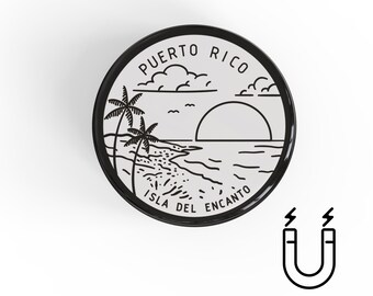 May include: A round black and white magnet featuring a beach scene with palm trees, the sun setting over the ocean, and the words "Puerto Rico" and "Isla Del Encanto". A magnet symbol is shown.