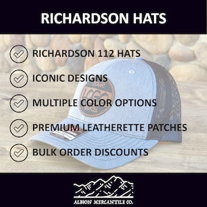 May include: A blue and black Richardson 112 hat with a brown leatherette patch that says "Your Logo Here". The hat is on a wooden surface with a background of rocks. The text "RICHARDSON HATS" is at the top of the image. The text "ICONIC DESIGNS", "MULTIPLE COLOR OPTIONS", "PREMIUM LEATHERETTE PATCHES", and "BULK ORDER DISCOUNTS" are listed below the hat. The text "ALBION MERCANTILE CO." is at the bottom of the image.