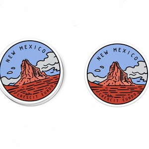 May include: A round sticker with a blue, white, and red illustration of a mountain range with the text "NEW MEXICO CRESCIT EUNDO" in a circle around the image.