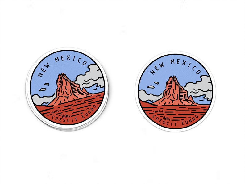 May include: A round sticker with a blue, white, and red illustration of a mountain range with the text "NEW MEXICO CRESCIT EUNDO" in a circle around the image.