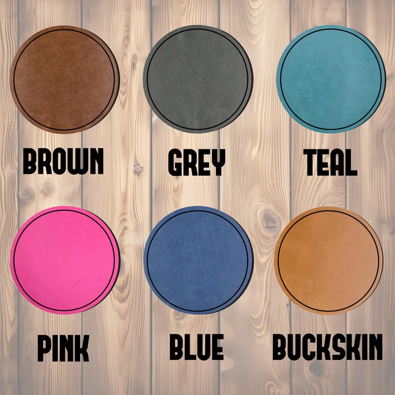 May include: A collection of six round coasters in various colors, including brown, grey, teal, pink, blue, and buckskin. Each coaster has a black border and a corresponding color name printed below.