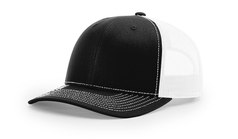 May include: A black and white trucker hat with a white mesh back. The hat has a curved brim and a white stitching detail.