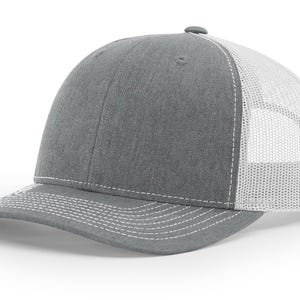 May include: A gray and white trucker hat with a mesh back. The hat has a curved brim and a white stitching detail.