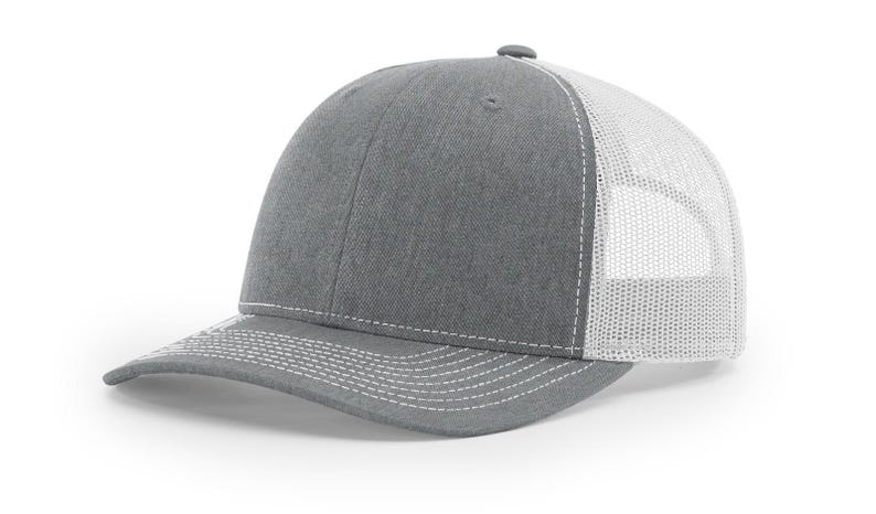 May include: A gray and white trucker hat with a mesh back. The hat has a curved brim and a white stitching detail.