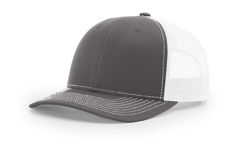May include: A gray and white trucker hat with a mesh back. The hat has a white stitching detail around the brim.
